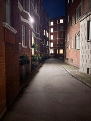 Urban Alleyway Illuminated at Night
