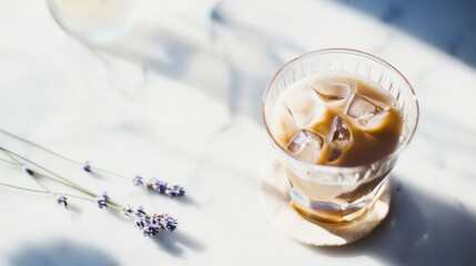 Vegan friendly iced latte with lavender infusion served on a marble table in soft afternoon light