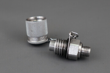 Plug test point or nipple test point with silver color and stainless steel material isolated on grey background.