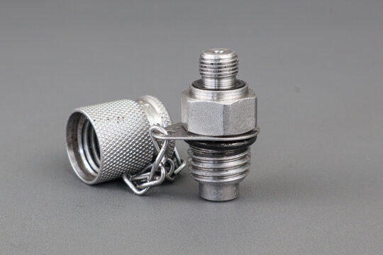 Plug test point or nipple test point with silver color and stainless steel material isolated on grey background.