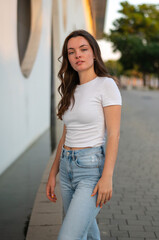 Young woman posing in urban setting wearing casual clothes