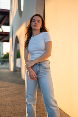 Young woman posing in urban setting during golden hour
