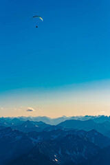 Alpine summer view with a paraglider at Mount Zugspitze, Top of Germany, Garmisch, Partenkirchen, Werdenfelser Land, Bavaria, Germany
