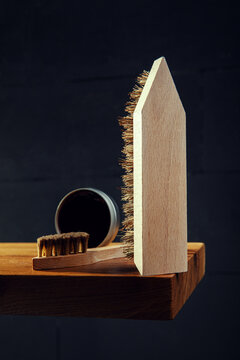 Wooden Shoe Brushes and Polish on Dark Background &ndash; Vertical Composition