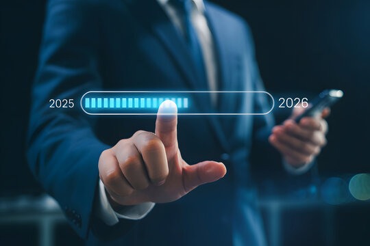 Man in suit touching progress bar from 2025 to 2026 holding phone finger