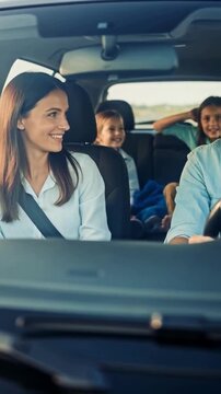Happy family with children enjoying a road trip together in their car, representing family bonding, travel, vacation and the joy of shared memories