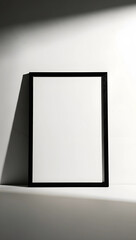 Minimalist Black Frame Leaning Against a White Wall with Dramatic Shadows