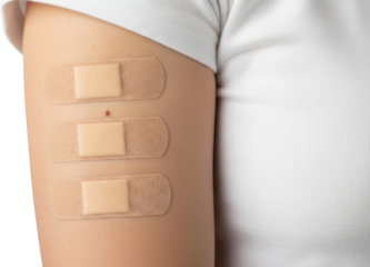 Close up of a person's arm with three adhesive bandages applied white t shirt isolate