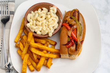 chicken sausage sandwich  with fries and macaroni salad