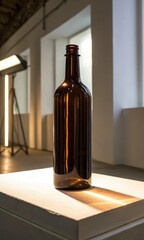 A sleek brown glass bottle on a lighted surface with a modern backdrop.