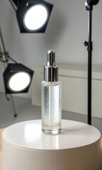 A sleek glass dropper bottle on a pedestal with spotlighting.
