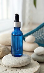 A blue glass dropper bottle on a stack of smooth stones in a serene setting.