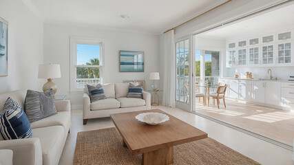 Fototapeta premium Bright and airy coastal living room and kitchen interior design with neutral tones and natural light creating a modern and relaxed atmosphere