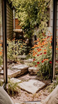 Enjoy the serene view of a vibrant garden filled with native plants from a cozy window seat. The lush landscape showcases the beauty of rewilding and sustainability, inviting calmness