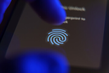 Smartphone screen showing fingerprint sensor prompt for secure access with a finger approaching the...