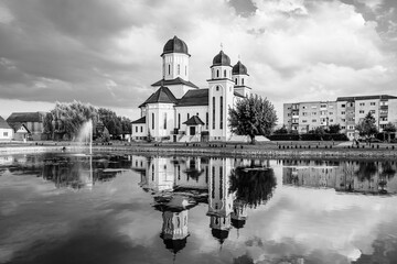 Sebeș, Alba county, Transylvania, Romania: The Orthodox Cathedral reflected in the lake water at sunset in black and white