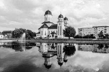Sebeș, Alba county, Transylvania, Romania: The Orthodox Cathedral reflected in the lake water at sunset in black and white
