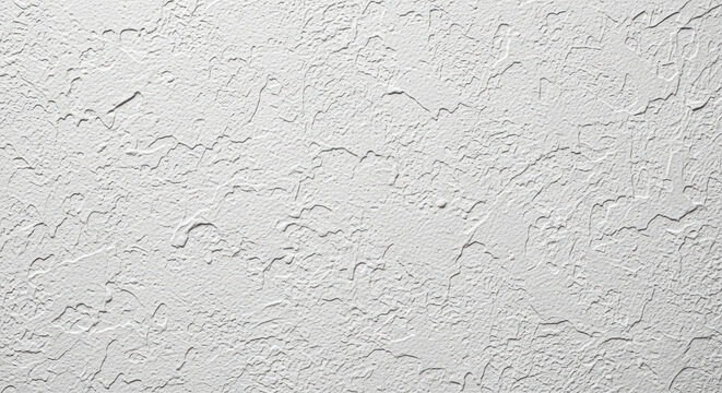 White ceiling or wall surface with a popcorn or cottage cheese texture providing a classic and highly tactile background