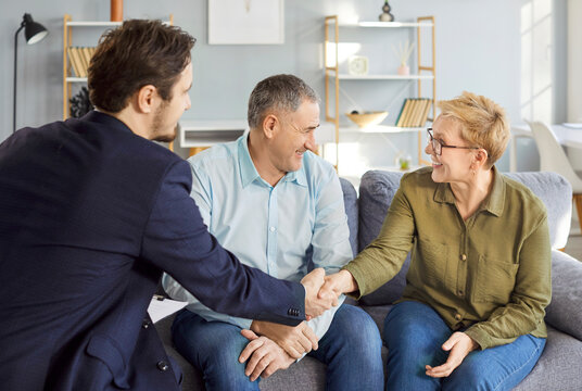 Consulting legal expert at home, happy senior mature family couple of clients meeting lawyer, solicitor asking advice, question, talking, celebrating deal, house or medical insurance buying deal - Powered by Adobe