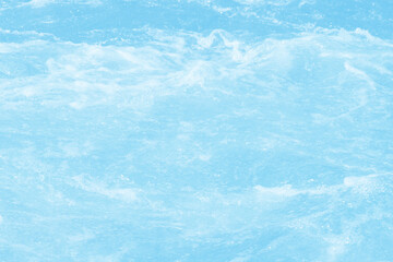 Obraz premium Blue water with ripples on the surface. Defocus blurred transparent blue colored clear calm water surface texture with splashes and bubbles. Water waves with shining pattern texture background.