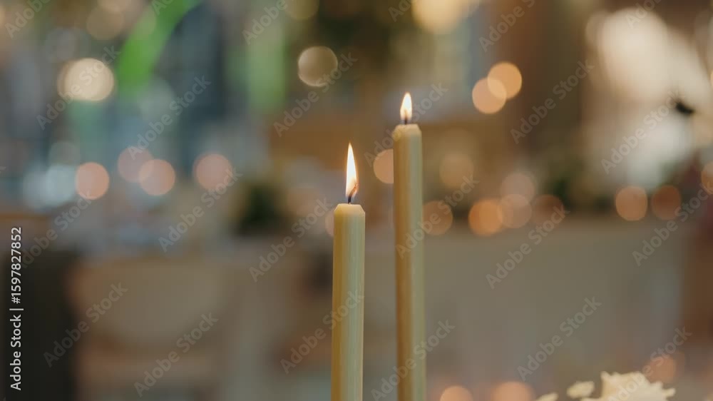 Poster two lit candles glow softly in elegant reception bokeh backdrop