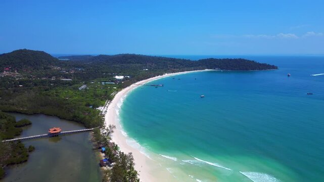 Long Set Beach in Koh Rong island, featuring turquoise waters, white sand beache and lush tropical vegetation. Perfect aerial view flight drone shot footage from above