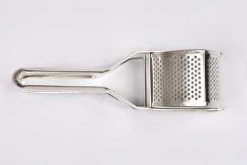 A stainless steel potato ricer lying horizontally on a white background.