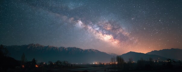 Starlit night sky showcasing the Milky Way over snow-covered mountains and glowing towns