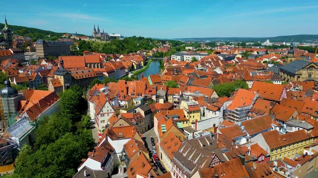 4K Aerial Drone Video of Construction Cranes near the Bamberg Cathedral and Michaelsberg Abbey along the Regnitz River in the Historic Old Town Area of Bamberg, Germany