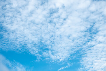 Blue sky with white clouds on sunny day, bright summer weather, nature background
