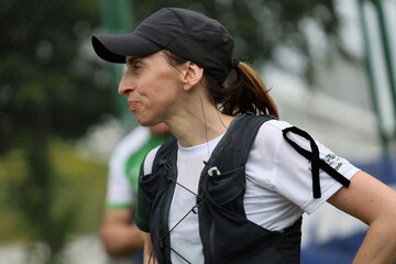 Female runner with black ribbon on her arm happy after finishing sport event
