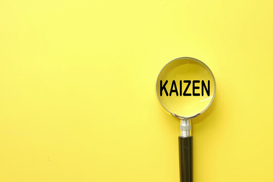 Magnifying glass over the word KAIZEN on a vibrant yellow backdrop. Concept of searching for opportunities for improvement, root cause analysis, and business strategy. Lean management and efficiency.