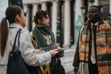 A candid image of three individuals, dressed warmly, engaging in conversation outside an elegant...