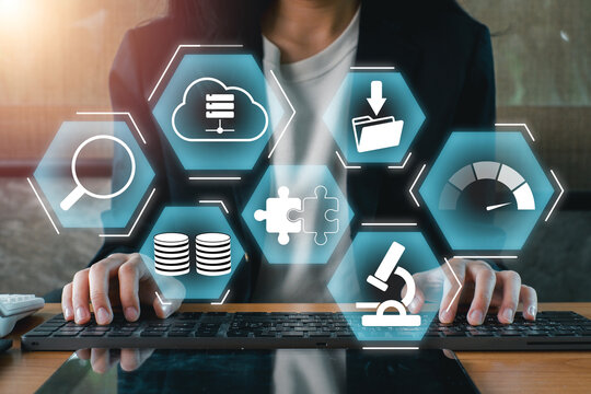 Businesswoman interacting with digital icons representing big data, analytics, and cloud computing on a futuristic interface.