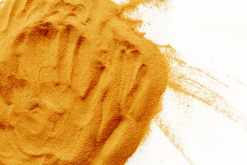Handprint in yellow sand texture for beach background, close up top view. Abstract sand surface
