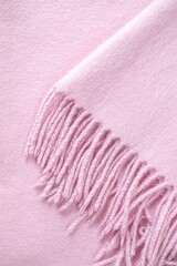 Cashmere pink stole. Texture, background, drapery. Fabric made of natural wool and silk, pastel pink color.