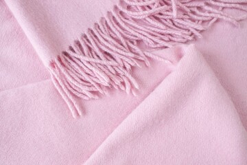 Cashmere pink stole. Texture, background, drapery. Fabric made of natural wool and silk, pastel pink color.