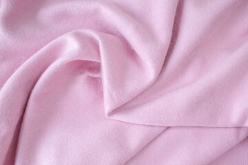 Cashmere pink stole. Texture, background, drapery. Fabric made of natural wool and silk, pastel pink color.