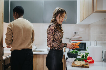 A man and woman cooking together in a contemporary kitchen, showcasing teamwork and a harmonious...