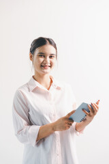 Asian woman rejoicing, looking happy, champion, fist pump gesture, standing over white background....