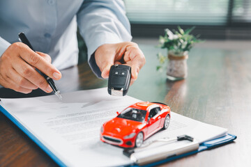 Businesswoman signing car insurance document or lease paper. Writing signature on contract or...