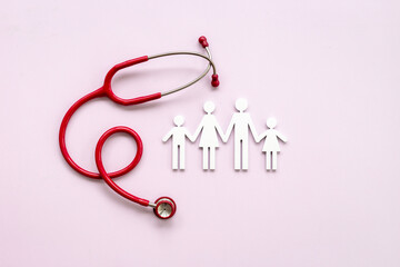Fototapeta premium Family wooden figure with medical stethoscope - health care and insurance concept. top view