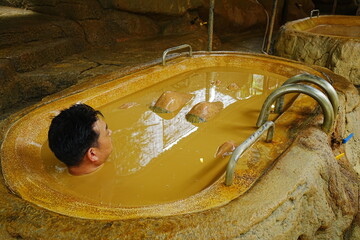 Man relaxing in Mud Bath in Nha Trang, Vietnam - ベトナム ニャチャン 泥風呂に入る男性