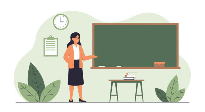 Female Teacher Presenting Lesson In Classroom With Blackboard And Books