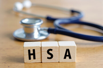 Wooden Block Puzzle with Stethoscope and HSA Spelling on Table