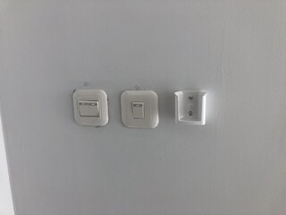 Clean minimalist layout of multiple switches mounted on a light background wall. Ideal for use in...