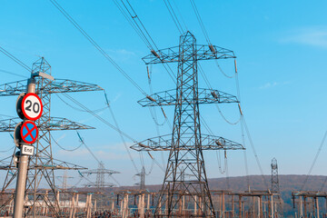 Tall power lines dominate the landscape under clear blue sky showing infrastructure that supports...