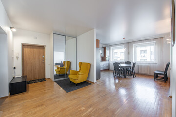 Home Entrance Hall. Interior. Wooden Door, Brown Flooring and White Walls. Kitchen Area