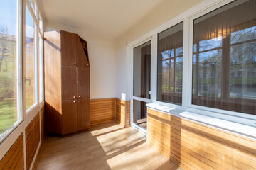 Home Interior of cozy balcony with wooden walls. Sunlight.
