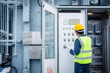 Engineer is working on high voltage power substation performing inspection and check of electrical...